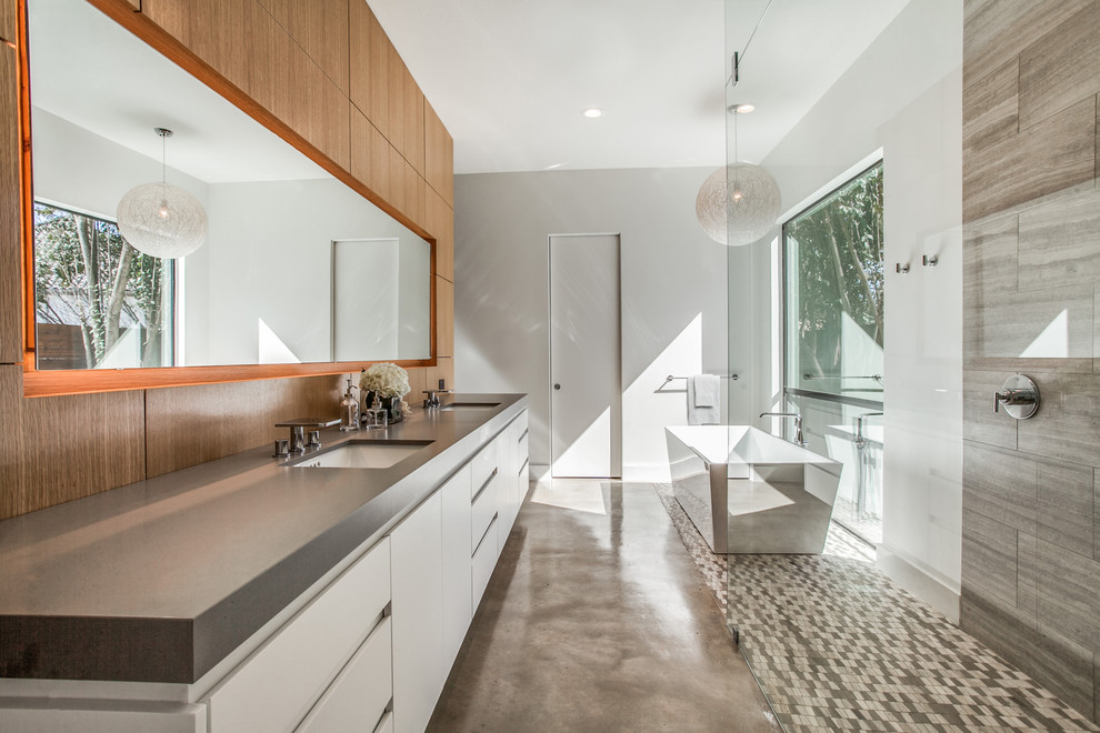 Contemporary ensuite wet room bathroom in Dallas with flat-panel cabinets, white cabinets, a freestanding bath, grey tiles, concrete flooring, a submerged sink, grey floors, an open shower, grey worktops and white walls.