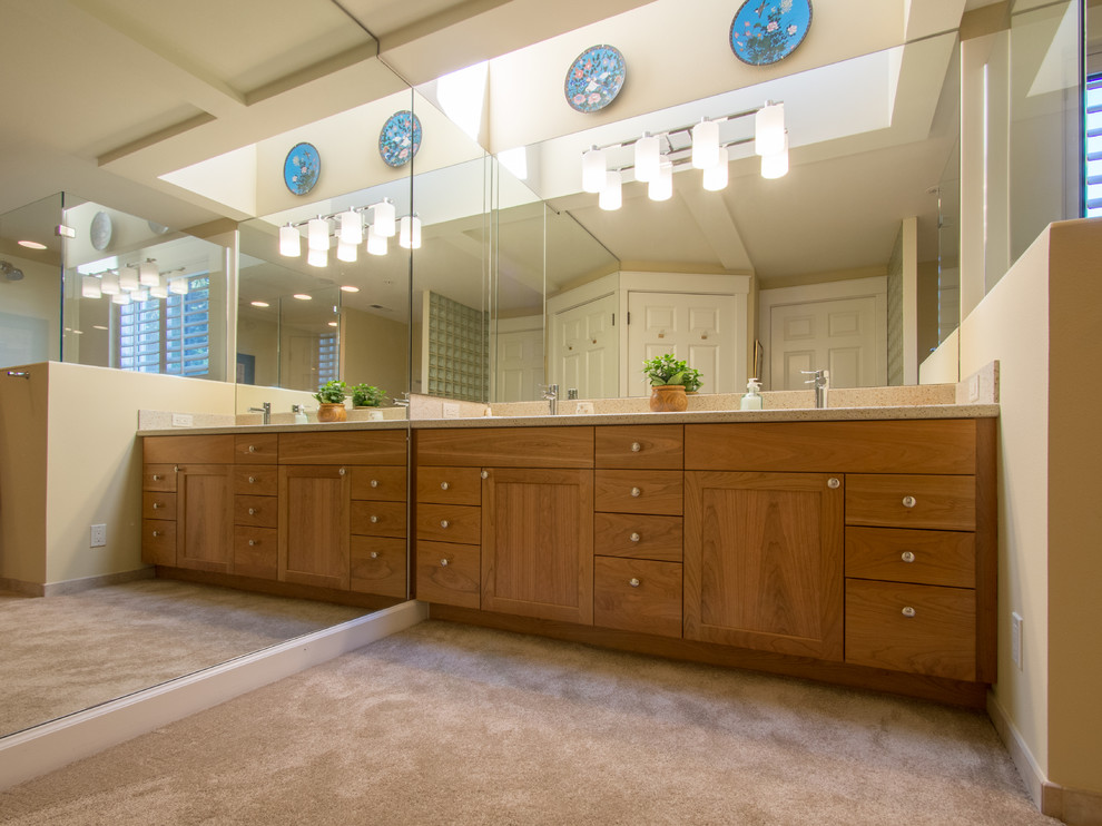 This is an example of a medium sized traditional ensuite bathroom in Seattle with shaker cabinets, medium wood cabinets, a double shower, a two-piece toilet, beige tiles, porcelain tiles, beige walls, porcelain flooring, an integrated sink, solid surface worktops, beige floors, a hinged door, beige worktops, a shower bench, double sinks, a built in vanity unit and a drop ceiling.