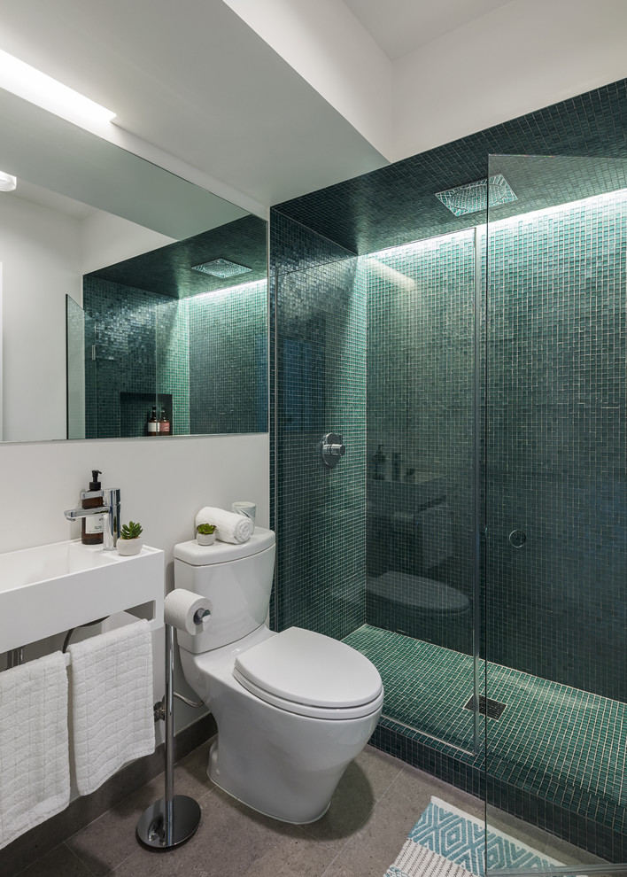 Réalisation d'une douche en alcôve design avec un carrelage vert, mosaïque, un mur blanc, un lavabo suspendu, un sol gris et une cabine de douche à porte battante.