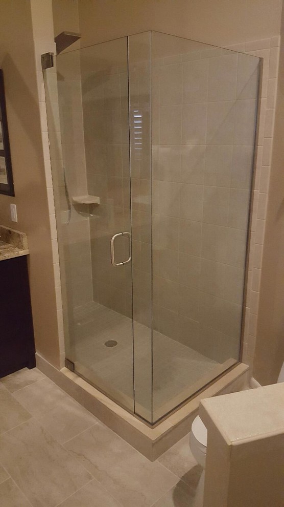 Example of a mid-sized minimalist 3/4 beige tile and porcelain tile porcelain tile corner shower design in Orlando with dark wood cabinets, a one-piece toilet, beige walls and granite countertops