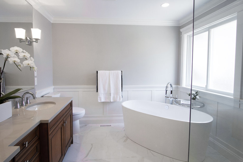 Large elegant master white tile and porcelain tile porcelain tile bathroom photo in Vancouver with an undermount sink, shaker cabinets, medium tone wood cabinets, quartz countertops and gray walls