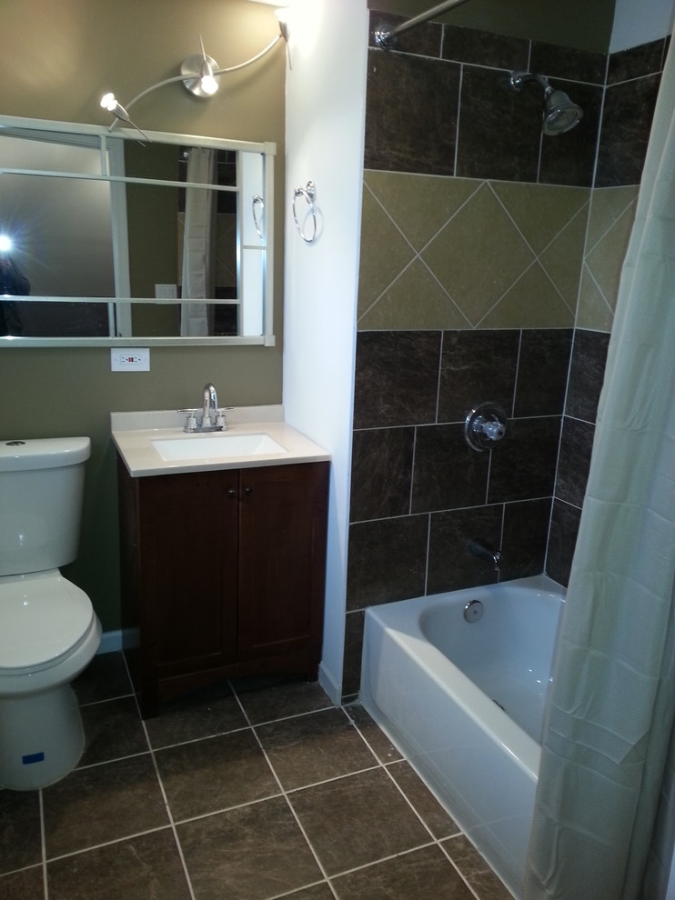 Example of a minimalist brown tile and ceramic tile bathroom design in Chicago with an undermount sink, furniture-like cabinets, medium tone wood cabinets, quartz countertops and a two-piece toilet