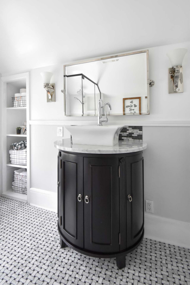 Example of a mid-sized transitional 3/4 marble floor, gray floor and single-sink corner shower design in Portland with black cabinets, gray walls, a vessel sink, quartz countertops, a hinged shower door, gray countertops, a niche, a freestanding vanity and recessed-panel cabinets