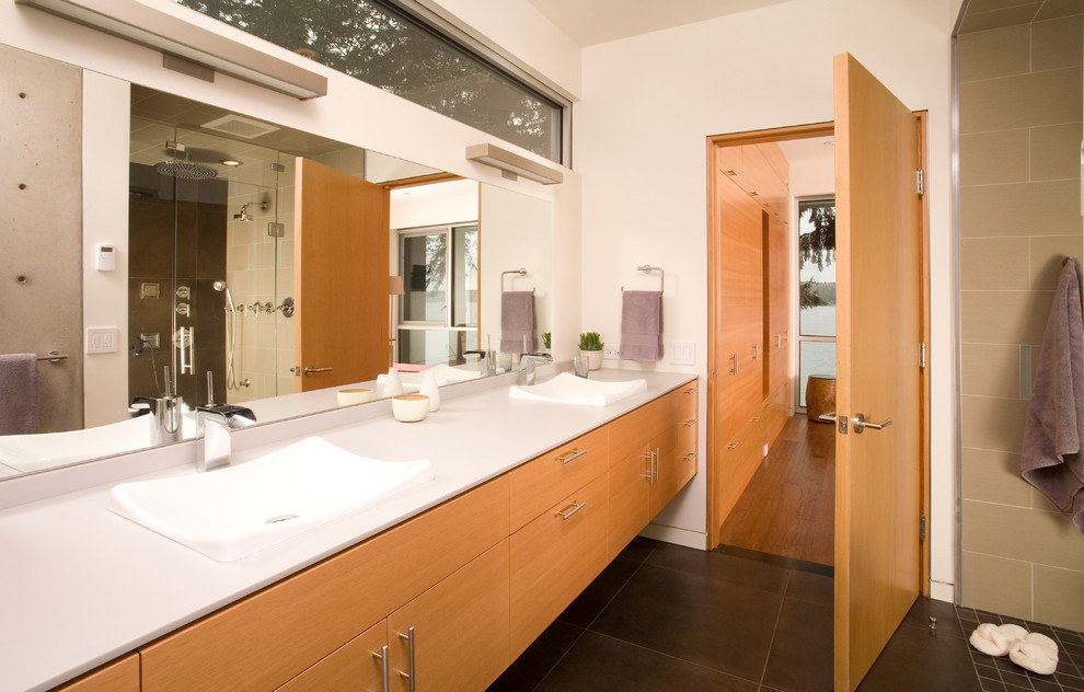 Ejemplo de cuarto de baño contemporáneo con lavabo sobreencimera, armarios con paneles lisos, puertas de armario de madera clara, ducha empotrada y baldosas y/o azulejos marrones