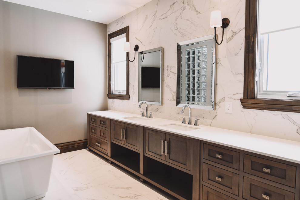 Large transitional master white tile and porcelain tile porcelain tile and white floor bathroom photo in Montreal with shaker cabinets, medium tone wood cabinets, an undermount sink, quartz countertops, a one-piece toilet, white walls and a hinged shower door