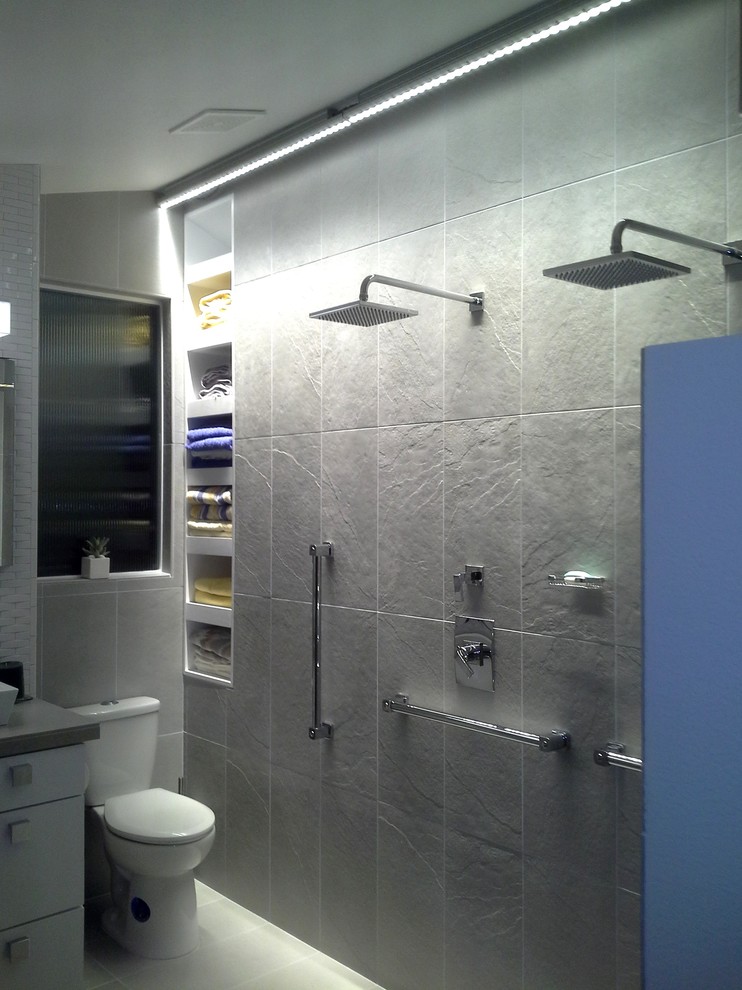 Design ideas for a small contemporary ensuite bathroom in San Diego with a vessel sink, flat-panel cabinets, white cabinets, a walk-in shower, a two-piece toilet, grey tiles, porcelain tiles, white walls and porcelain flooring.