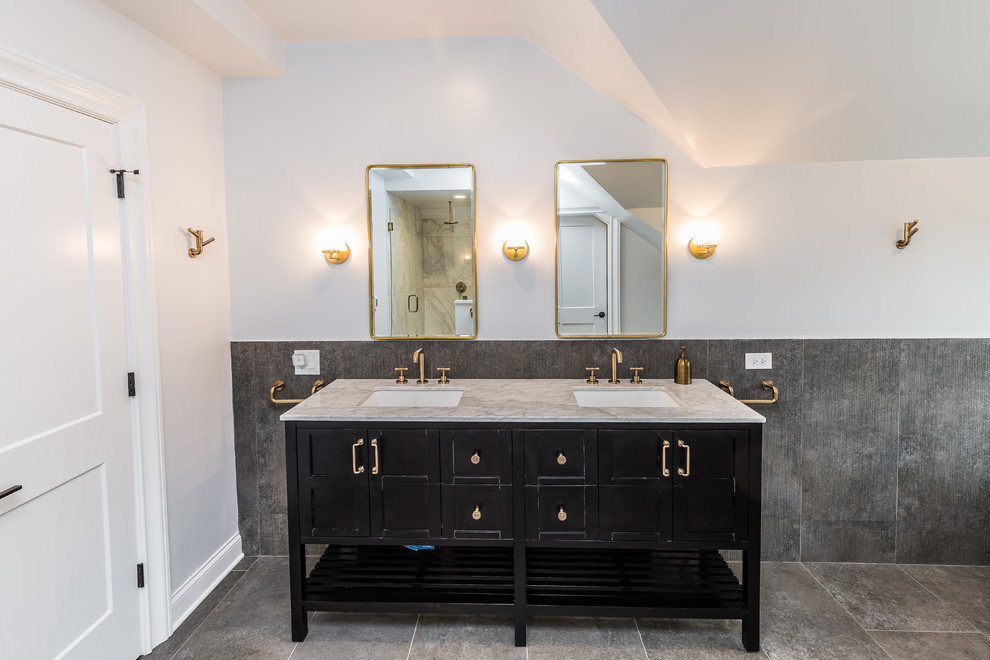 Example of a large classic master porcelain tile gray floor claw-foot bathtub design in Chicago with shaker cabinets, black cabinets, white walls, an undermount sink, marble countertops and gray countertops