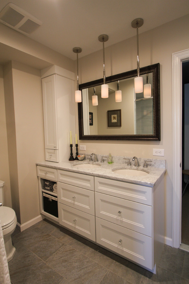 This is an example of a medium sized traditional ensuite bathroom in Philadelphia with white cabinets, white tiles, metro tiles, beige walls, a submerged sink, marble worktops, recessed-panel cabinets, an alcove shower, a two-piece toilet and lino flooring.
