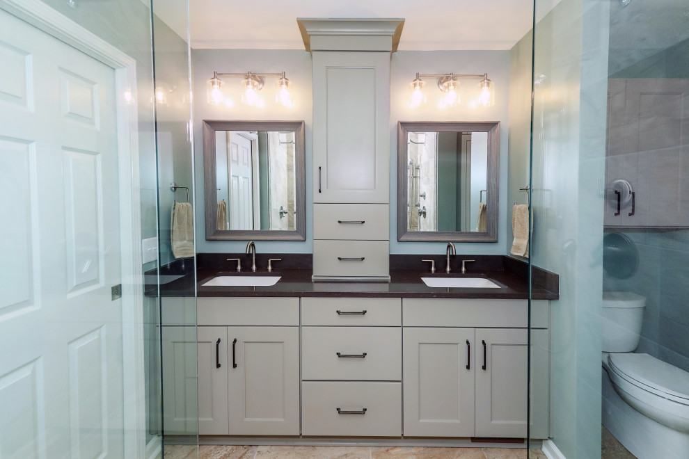 Inspiration for a medium sized classic ensuite bathroom with recessed-panel cabinets, beige cabinets, an alcove shower, a two-piece toilet, green walls, porcelain flooring, a submerged sink, engineered stone worktops, beige floors, a hinged door, black worktops, a shower bench, double sinks and a built in vanity unit.