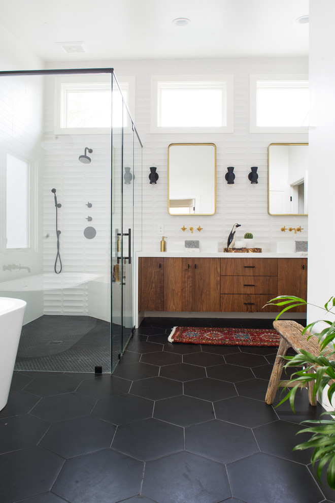 Inspiration for a medium sized retro ensuite bathroom in Orange County with flat-panel cabinets, dark wood cabinets, a freestanding bath, a built-in shower, white tiles, ceramic tiles, white walls, porcelain flooring, a vessel sink, engineered stone worktops, black floors and a hinged door.