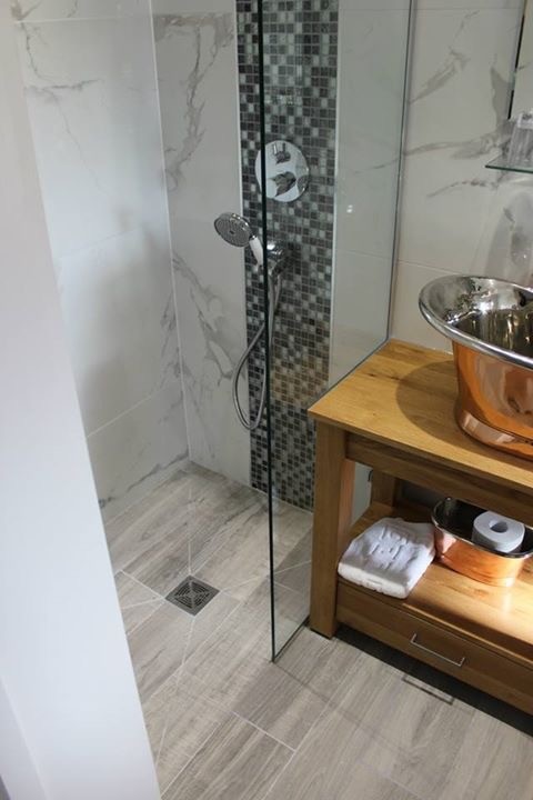 Photo of a medium sized classic ensuite bathroom in Dorset with a vessel sink, medium wood cabinets, wooden worktops, a freestanding bath, a walk-in shower, a two-piece toilet, white tiles, porcelain tiles and porcelain flooring.
