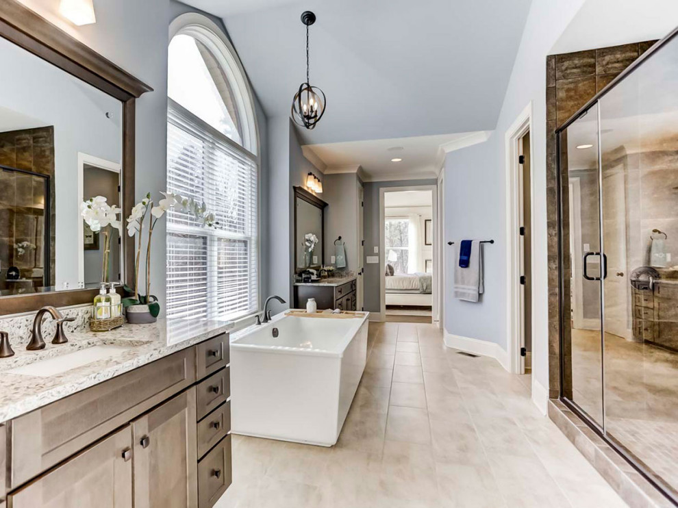 Huge master ceramic tile, beige floor, double-sink and vaulted ceiling bathroom photo in Charlotte with recessed-panel cabinets, distressed cabinets, blue walls, an undermount sink, quartz countertops, a hinged shower door and a built-in vanity