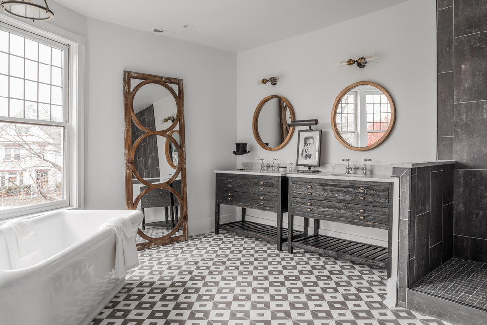 Traditional ensuite bathroom in Indianapolis with grey cabinets, a freestanding bath, a corner shower, grey tiles, white walls, a submerged sink, grey floors, an open shower and flat-panel cabinets.