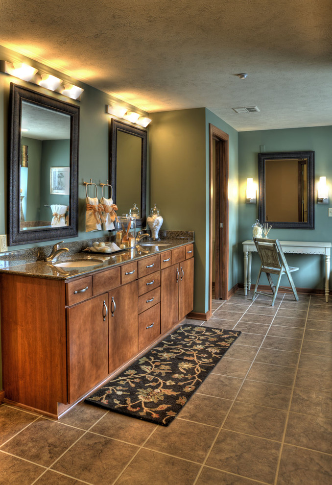 Large trendy master gray tile and ceramic tile ceramic tile and brown floor bathroom photo in Wichita with medium tone wood cabinets, green walls, an undermount sink, granite countertops and flat-panel cabinets