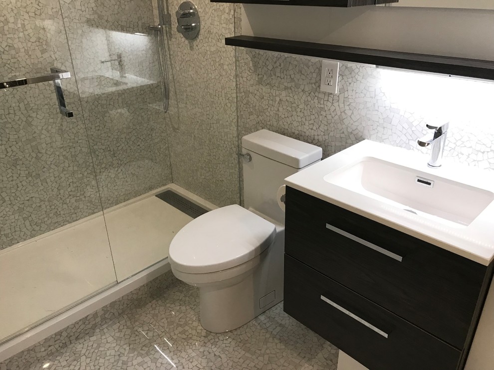 Design ideas for a small contemporary bathroom in Toronto with flat-panel cabinets, medium wood cabinets, an alcove shower, a one-piece toilet, grey tiles, porcelain tiles, grey walls, porcelain flooring, a wall-mounted sink, quartz worktops, grey floors, a hinged door and white worktops.