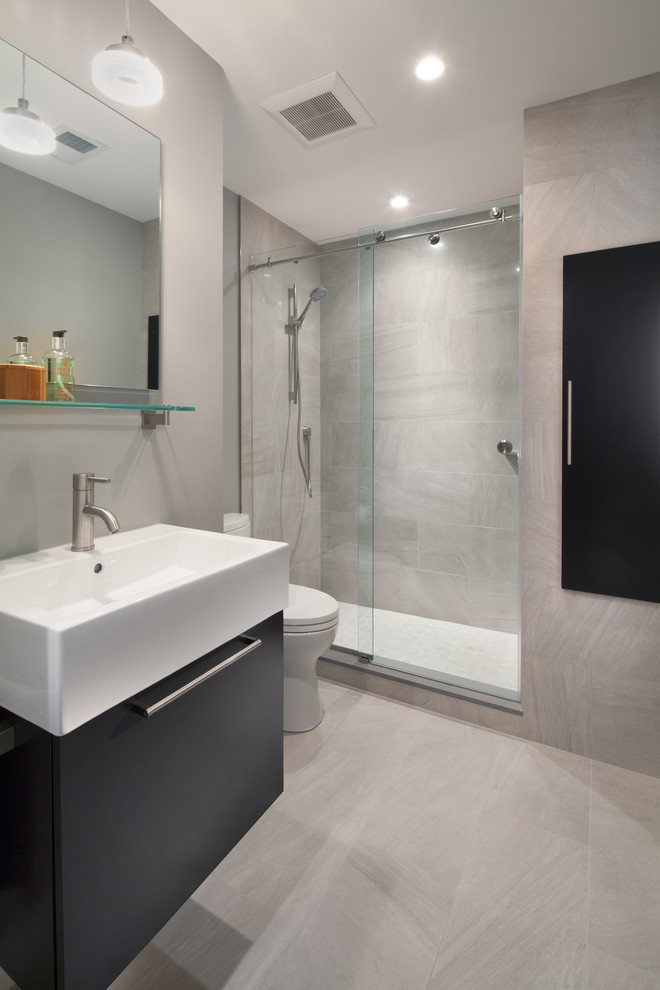 Mid-sized trendy 3/4 beige tile and ceramic tile ceramic tile alcove shower photo in DC Metro with flat-panel cabinets, black cabinets, a one-piece toilet, gray walls and a vessel sink
