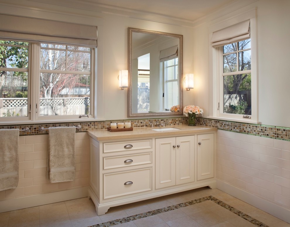 Large transitional master beige tile and ceramic tile ceramic tile and beige floor bathroom photo in San Francisco with raised-panel cabinets, white cabinets, a one-piece toilet, beige walls, a drop-in sink and soapstone countertops