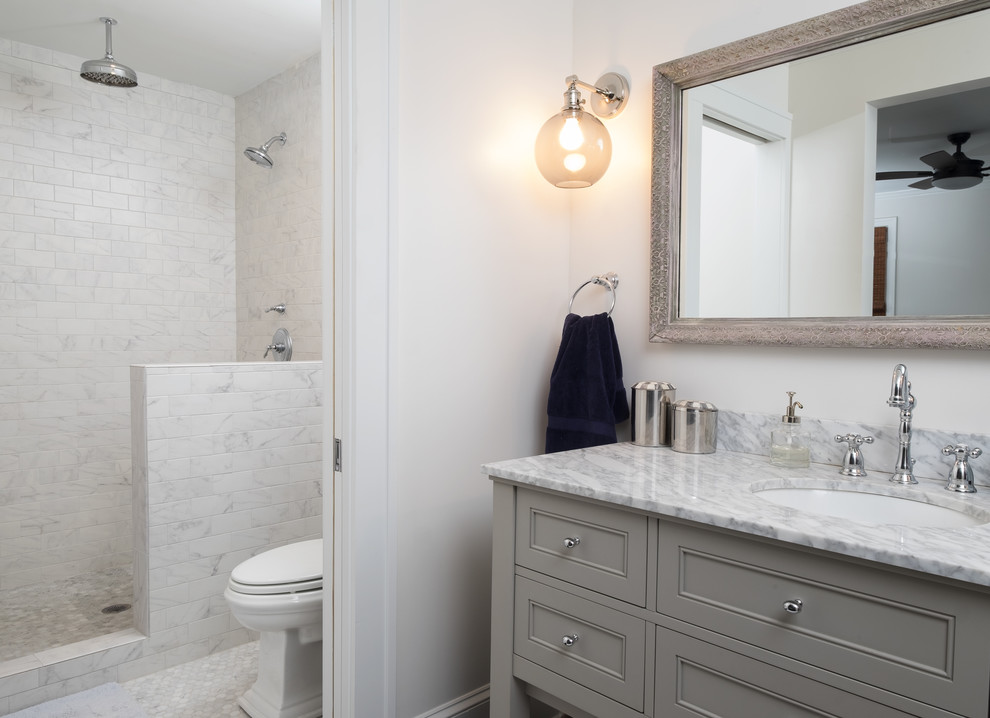 Inspiration for a medium sized traditional shower room bathroom in Atlanta with a walk-in shower, a two-piece toilet, white tiles, white walls, mosaic tile flooring, a submerged sink, beaded cabinets, grey cabinets, marble tiles and quartz worktops.