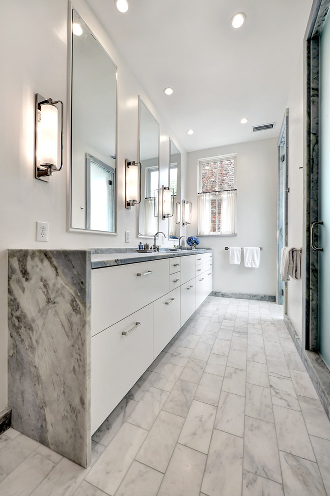 Photo of a classic bathroom in Charleston with flat-panel cabinets, white cabinets, an alcove shower, white walls, a submerged sink, grey floors, a hinged door and grey worktops.