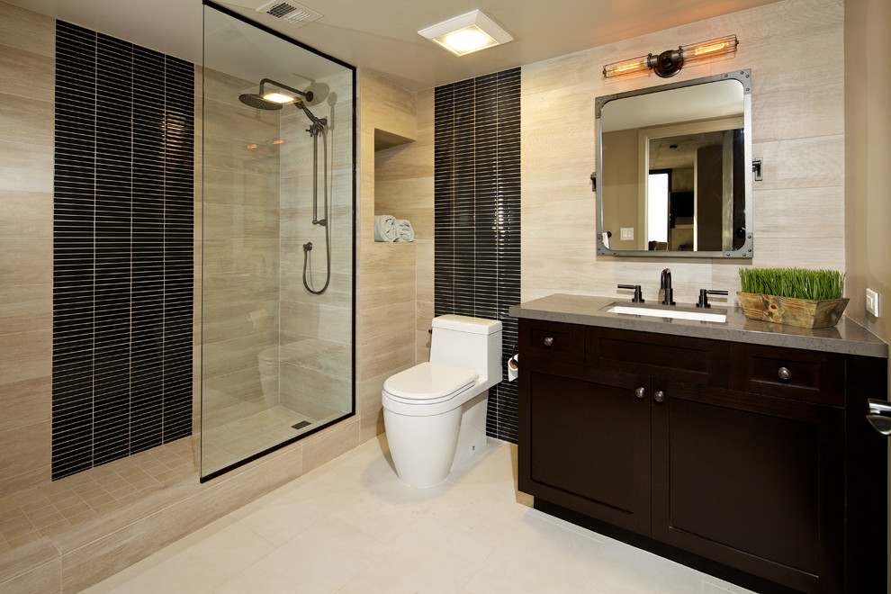 Trendy master brown tile and matchstick tile porcelain tile doorless shower photo in San Diego with an undermount sink, recessed-panel cabinets, dark wood cabinets and beige walls