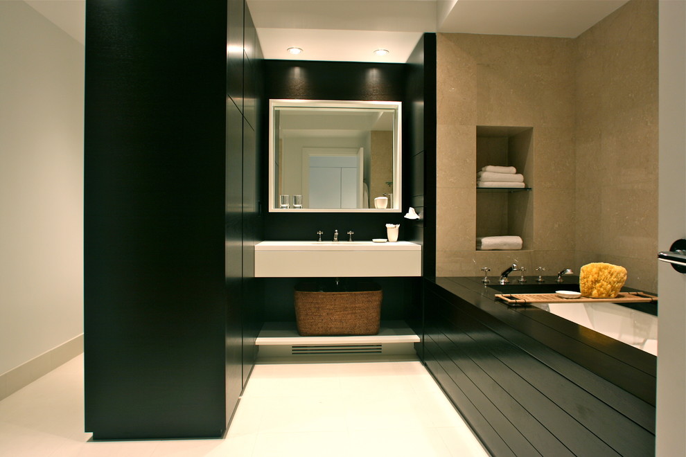 Inspiration for a medium sized contemporary ensuite bathroom in New York with a submerged sink, flat-panel cabinets, dark wood cabinets, solid surface worktops, a submerged bath, an alcove shower, a wall mounted toilet, white tiles, ceramic tiles, beige walls and ceramic flooring.