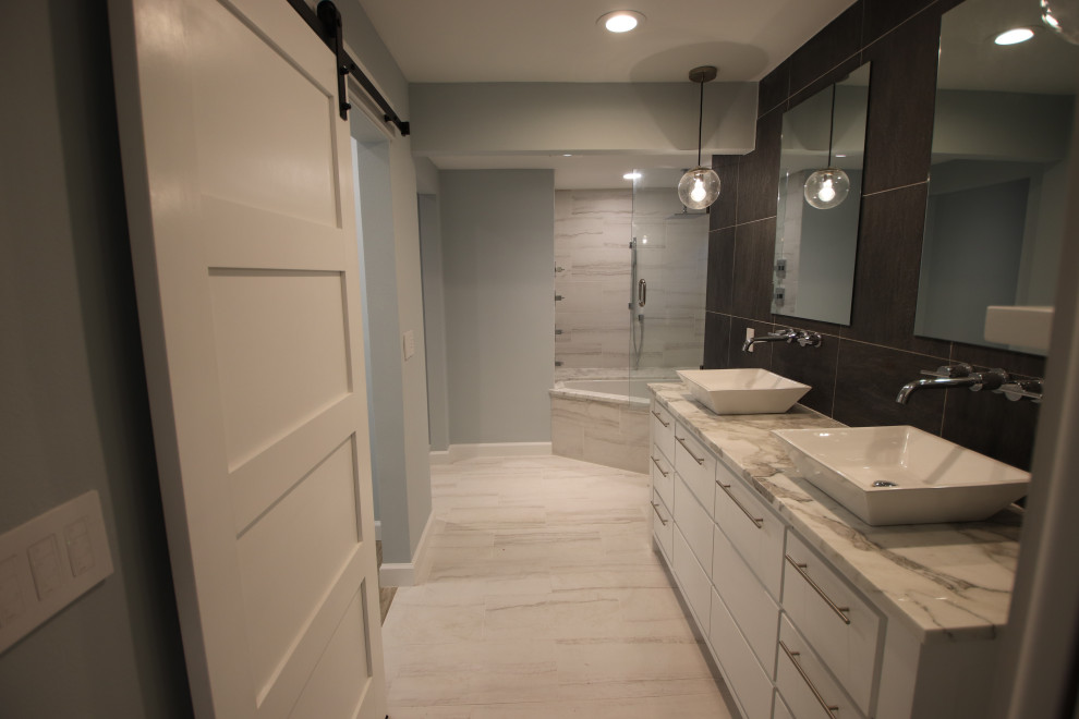 Идея дизайна: главная ванная комната среднего размера в современном стиле с плоскими фасадами, белыми фасадами, угловой ванной, угловым душем, разноцветной плиткой, керамогранитной плиткой, разноцветными стенами, полом из керамогранита, настольной раковиной, столешницей из кварцита, белым полом, душем с распашными дверями и разноцветной столешницей
