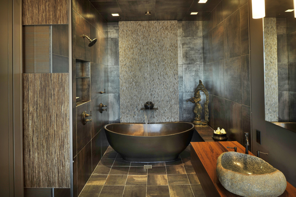 Cette photo montre une salle de bain asiatique avec une baignoire indépendante, mosaïque, une vasque, un plan de toilette en bois et un plan de toilette marron.