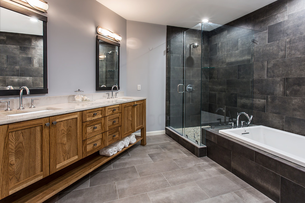 Bathroom - large industrial master black tile and porcelain tile porcelain tile and gray floor bathroom idea in Richmond with furniture-like cabinets, medium tone wood cabinets, a one-piece toilet, gray walls, an undermount sink, granite countertops and a hinged shower door