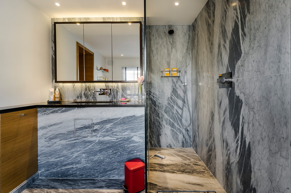 Example of a mid-sized trendy 3/4 gray tile and porcelain tile porcelain tile and gray floor bathroom design in London with flat-panel cabinets, gray cabinets, white walls, an undermount sink and black countertops