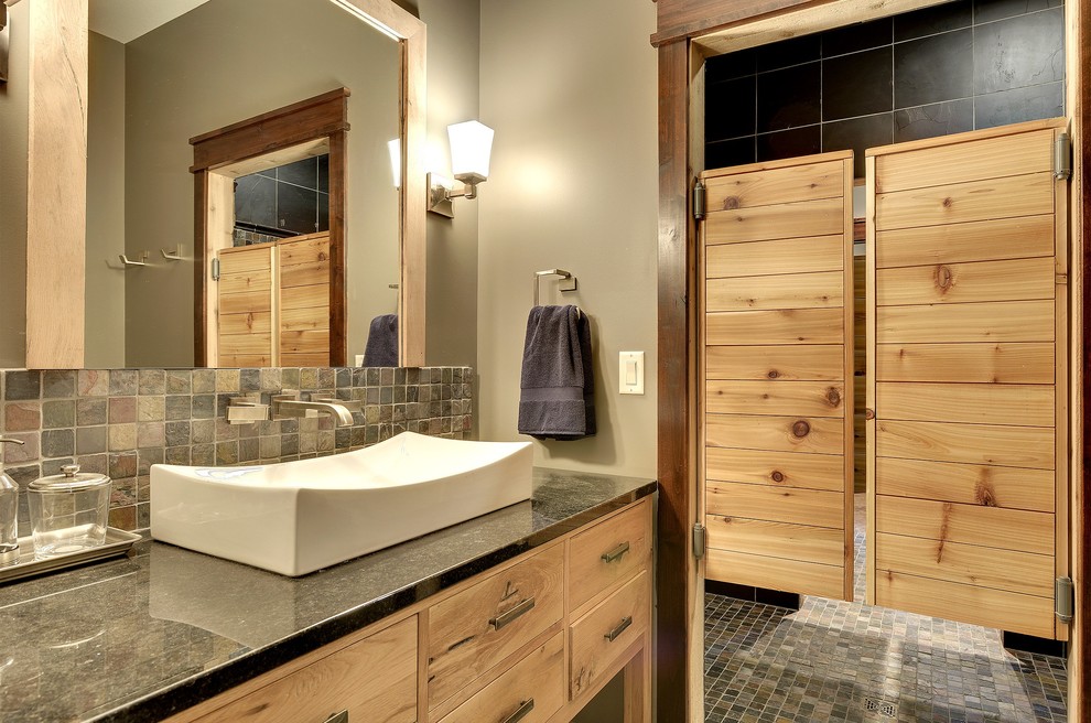 Design ideas for a medium sized classic ensuite bathroom in Minneapolis with a vessel sink, flat-panel cabinets, light wood cabinets, an alcove shower, grey tiles, multi-coloured tiles, stone tiles, grey walls, grey floors and a hinged door.