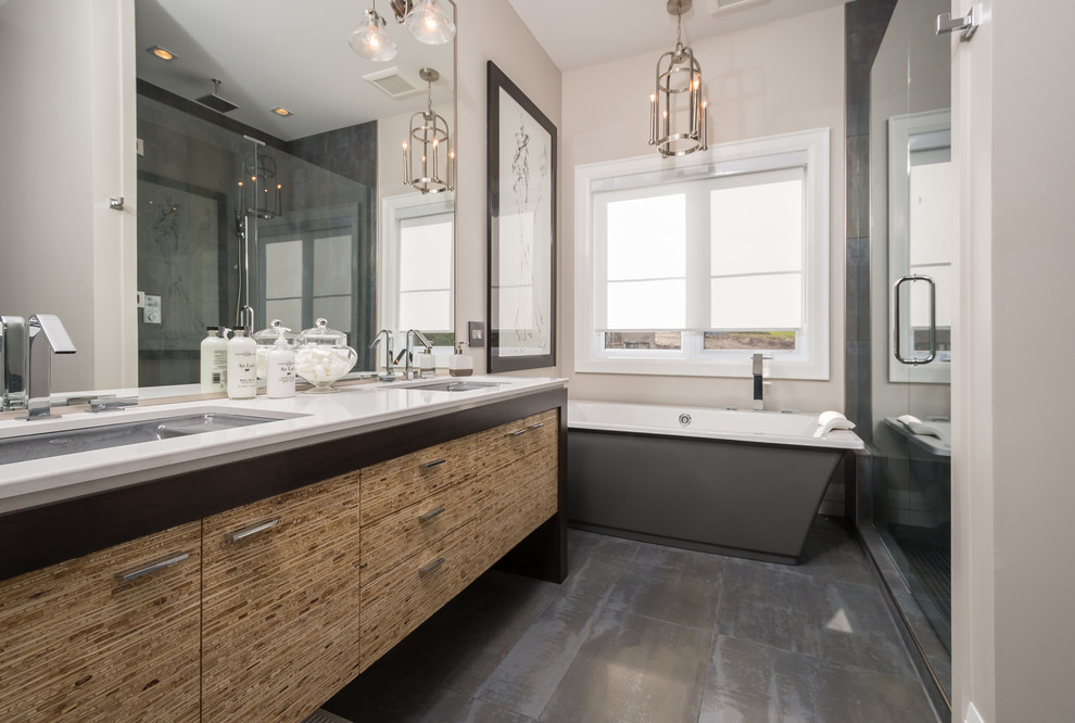 Inspiration for a medium sized contemporary ensuite bathroom in Toronto with a submerged sink, flat-panel cabinets, light wood cabinets, a freestanding bath, an alcove shower, grey tiles, beige walls, porcelain tiles, porcelain flooring and engineered stone worktops.