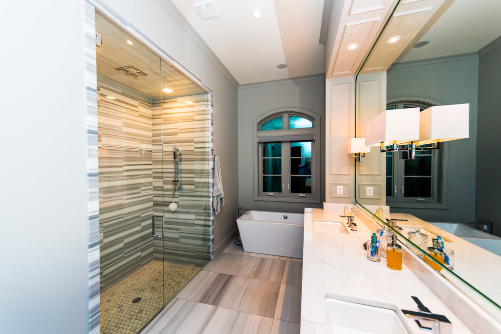 Inspiration for a large timeless master white tile and stone tile medium tone wood floor bathroom remodel in Jacksonville with an undermount sink, flat-panel cabinets, gray cabinets, quartzite countertops, a two-piece toilet and gray walls