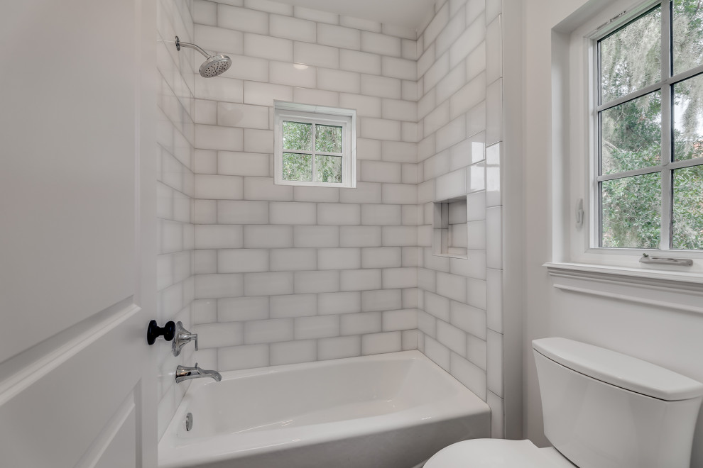 Design ideas for a large mediterranean family bathroom in Jacksonville with flat-panel cabinets, grey cabinets, an alcove bath, a two-piece toilet, white tiles, porcelain tiles, white walls, porcelain flooring, a submerged sink, engineered stone worktops, grey floors, white worktops, double sinks and a floating vanity unit.