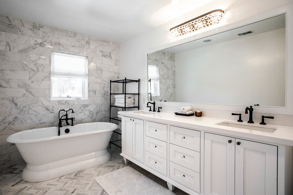 Photo of a large classic ensuite bathroom in Los Angeles with a submerged sink, shaker cabinets, white cabinets, a freestanding bath, white walls, marble flooring and grey tiles.