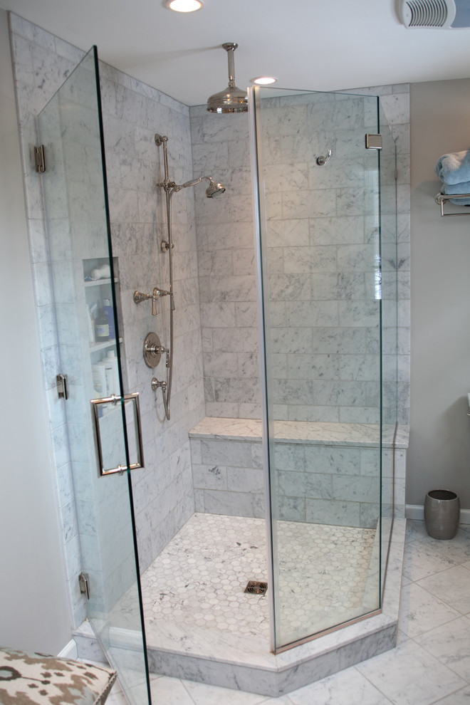 Photo of a large classic ensuite bathroom in Philadelphia with a submerged sink, recessed-panel cabinets, dark wood cabinets, marble worktops, a corner shower, a two-piece toilet, white tiles, stone tiles, grey walls and marble flooring.