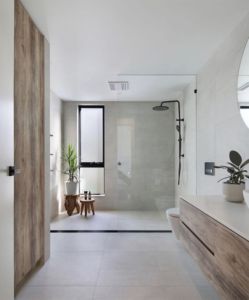 Inspiration for a large contemporary ensuite bathroom in Melbourne with raised-panel cabinets, white cabinets, a freestanding bath, a double shower, grey tiles, stone tiles, grey walls, concrete flooring, concrete worktops, grey floors, an open shower and white worktops.