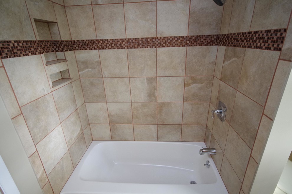 Drop in tub, porcelain tile, glass tile, shower cubby. Modern