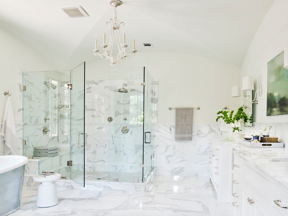 Inspiration for a traditional ensuite bathroom in Atlanta with a submerged sink, flat-panel cabinets, white cabinets, marble worktops, a freestanding bath, a corner shower, white tiles, stone tiles, white walls and marble flooring.