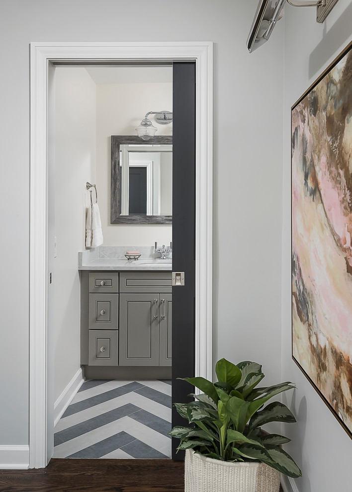 Example of a small transitional kids' gray tile and ceramic tile porcelain tile and gray floor bathroom design in Chicago with flat-panel cabinets, gray cabinets, a two-piece toilet, gray walls, an undermount sink and quartz countertops