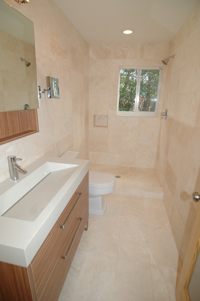 Doorless shower - mid-sized contemporary kids' travertine floor doorless shower idea in Miami with a trough sink, furniture-like cabinets, medium tone wood cabinets and a one-piece toilet