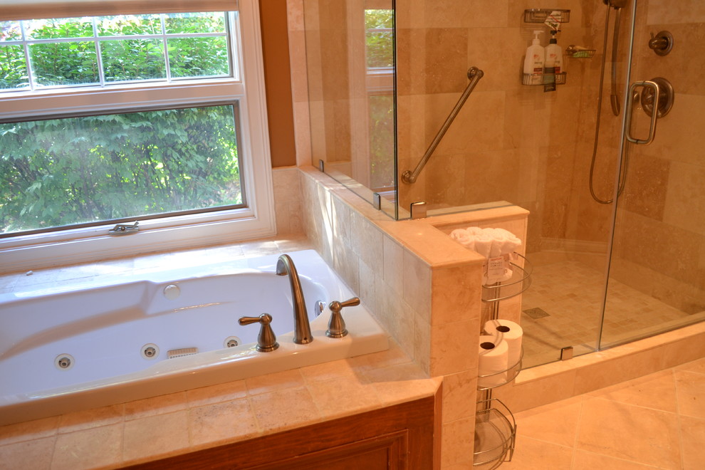 Photo of a small mediterranean ensuite bathroom in Columbus with recessed-panel cabinets, black cabinets, a corner bath, a corner shower, a two-piece toilet, beige tiles, stone tiles, beige walls, ceramic flooring and an integrated sink.