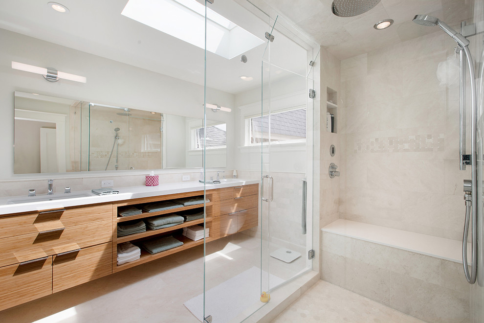 Corner shower - large modern master beige tile and ceramic tile ceramic tile corner shower idea in San Francisco with flat-panel cabinets, light wood cabinets, a one-piece toilet, beige walls, an undermount sink and quartzite countertops