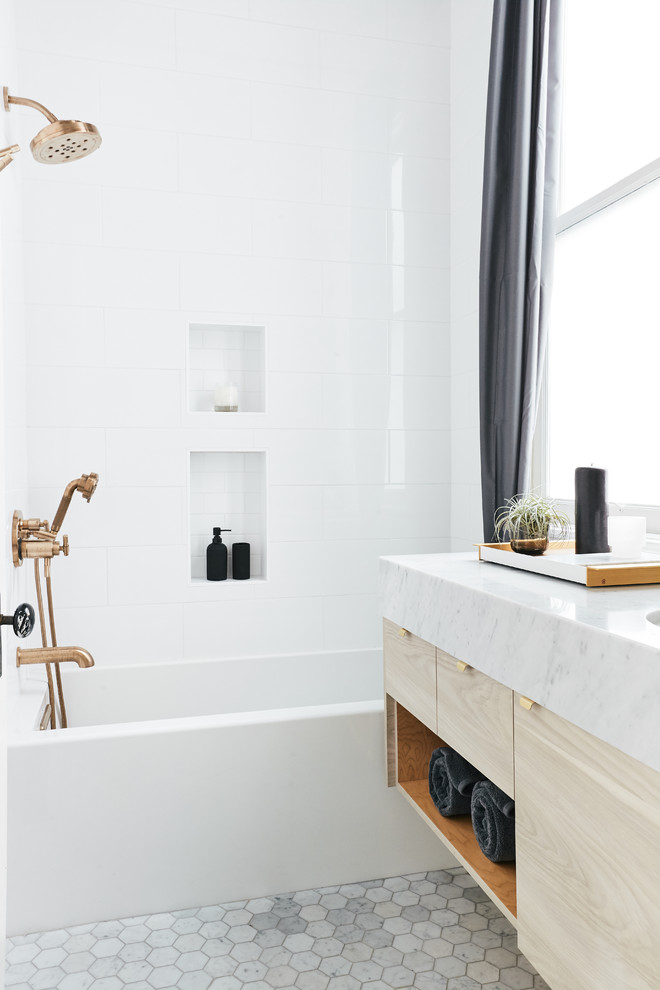 Bathroom - small traditional kids' white tile and porcelain tile marble floor and gray floor bathroom idea in San Francisco with flat-panel cabinets, light wood cabinets, a wall-mount toilet, white walls, an undermount sink, marble countertops and gray countertops