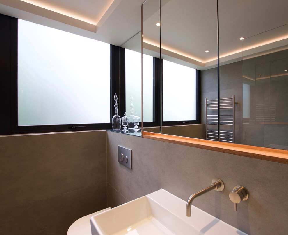 Inspiration for a contemporary ensuite bathroom in London with a walk-in shower, beige tiles and porcelain tiles.