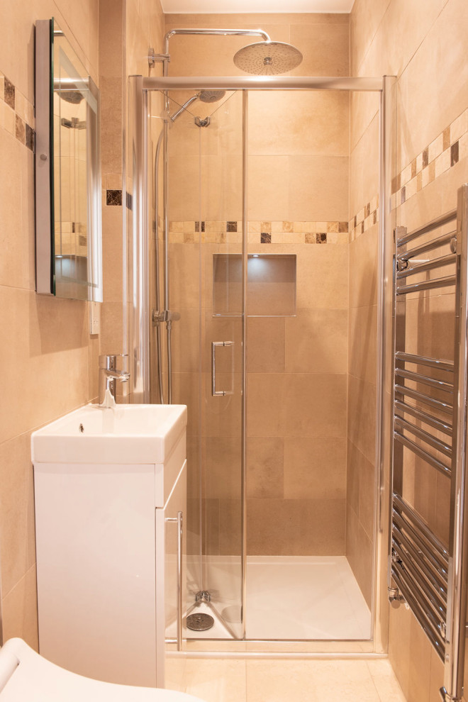 This is an example of a medium sized traditional family bathroom in London with recessed-panel cabinets, white cabinets, a freestanding bath, a built-in shower, a bidet, multi-coloured tiles, travertine tiles, beige walls, porcelain flooring, a console sink, solid surface worktops, beige floors, a hinged door, beige worktops, a single sink and a freestanding vanity unit.