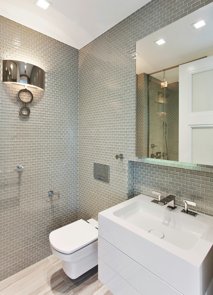 ニューヨークにあるトランジショナルスタイルのおしゃれな浴室 (コンソール型シンク、フラットパネル扉のキャビネット、白いキャビネット、アルコーブ型シャワー、グレーのタイル、ガラスタイル) の写真