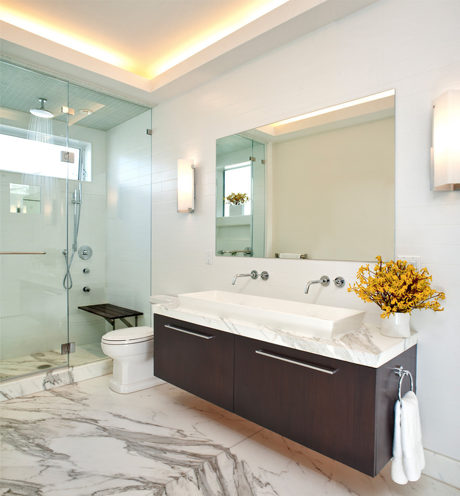 Пример оригинального дизайна: ванная комната в стиле модернизм с раковиной с несколькими смесителями, плоскими фасадами, темными деревянными фасадами, душем в нише, белой плиткой и мраморным полом
