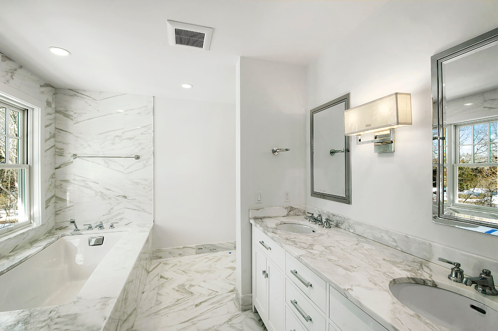 Photo of a medium sized classic ensuite bathroom in New York with shaker cabinets, white cabinets, a submerged bath, white walls, marble flooring, a submerged sink, marble worktops, white floors and white worktops.