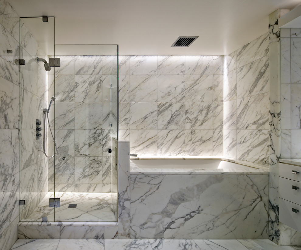 Inspiration for a small contemporary ensuite bathroom in New York with a submerged bath, a submerged sink, flat-panel cabinets, marble worktops, stone tiles, marble flooring, a corner shower, black tiles, black and white tiles, grey tiles and white tiles.