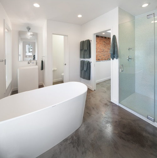 bathroom with white walls, bathtub, and shower